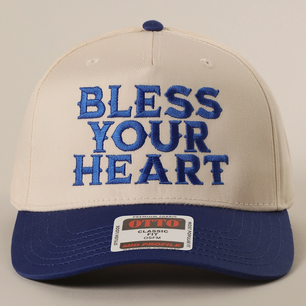 Cap with 'Bless Your Heart' text on a beige and blue background