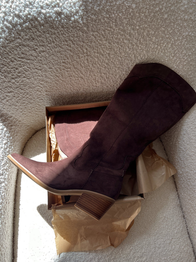 Brown shoe with a box on a textured surface